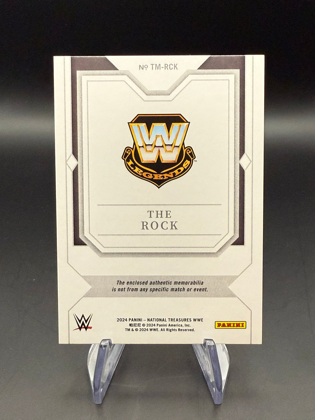 The Rock 2024 WWE Panini National Treasures Timeline Materials Holo Silver Relic /25