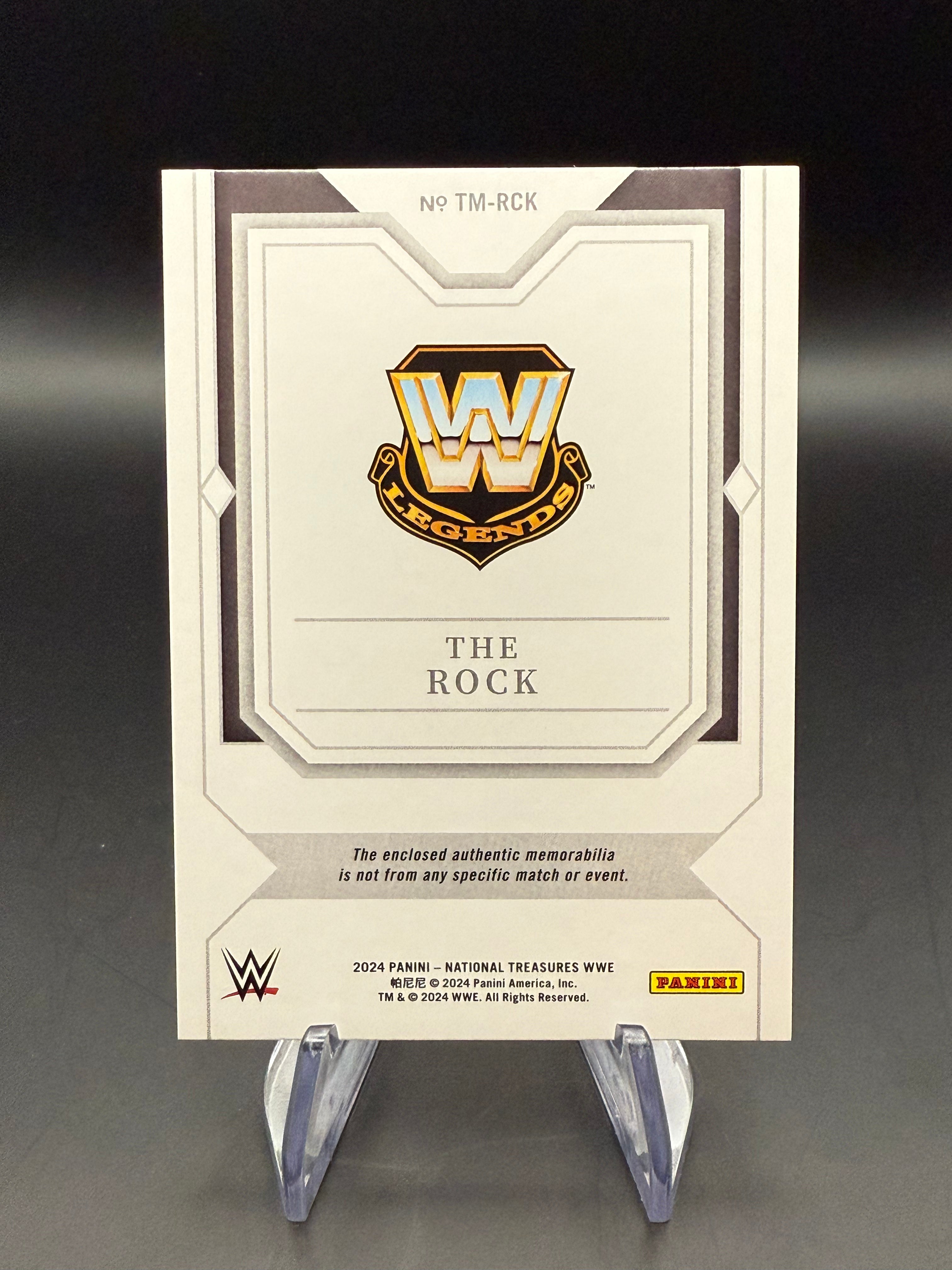 The Rock 2024 WWE Panini National Treasures Timeline Materials Holo Silver Relic /25